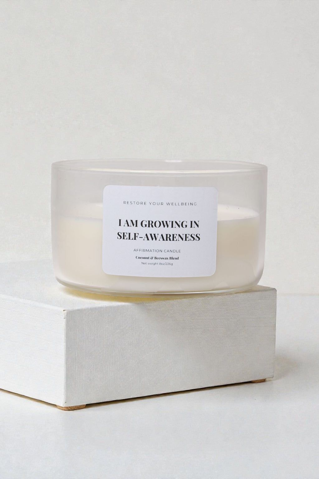 Clear 8 oz Calista glass candle labeled “I Am Growing in Self-Awareness” against a neutral background