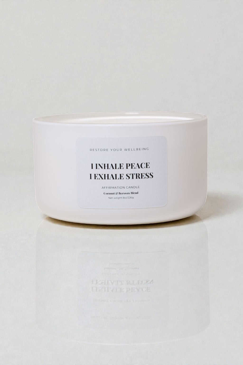 White 8 oz Calista glass candle labeled “Inhale Peace, Exhale Stress” against a neutral background