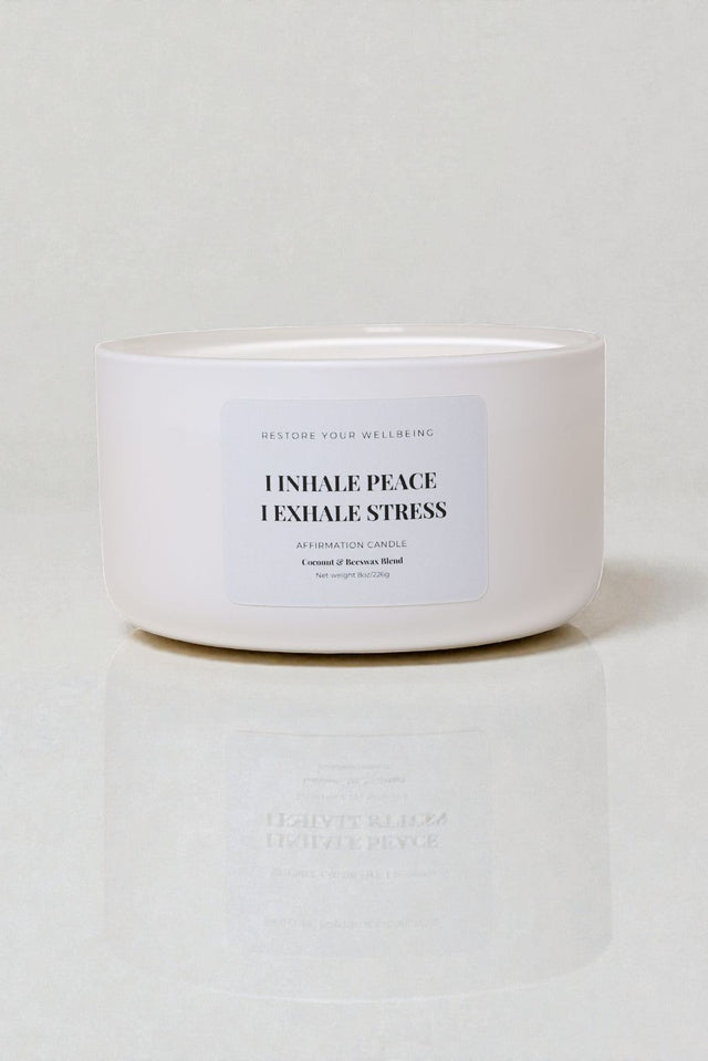 White 8 oz Calista glass candle labeled “Inhale Peace, Exhale Stress” against a neutral background